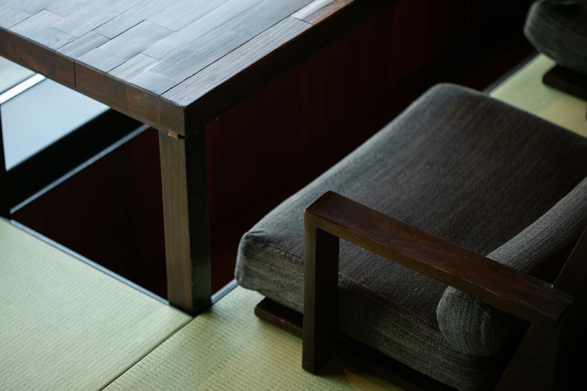 Tatami, a low timber table and upholstered floor seating inside a villa.